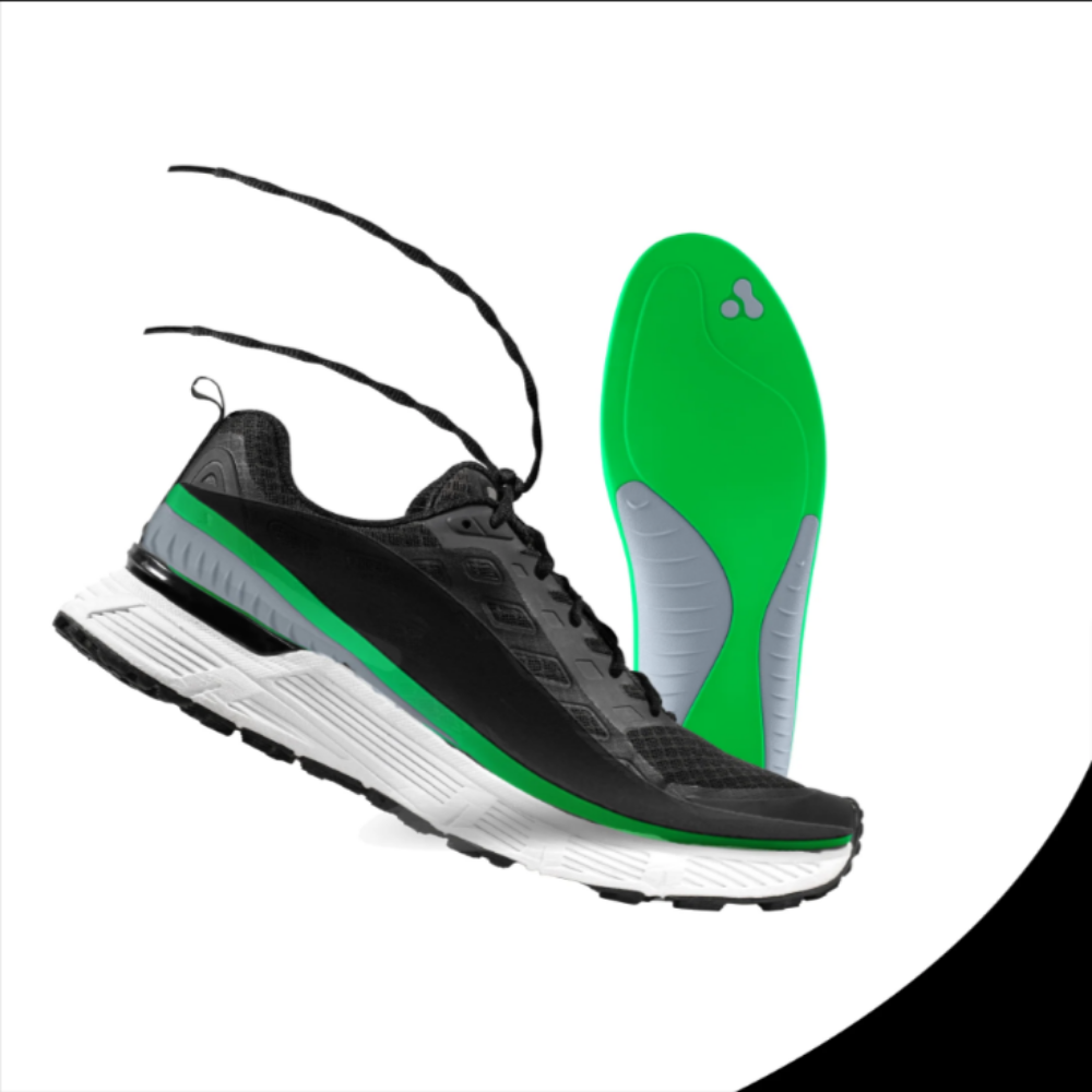 a pair of black and green running shoes