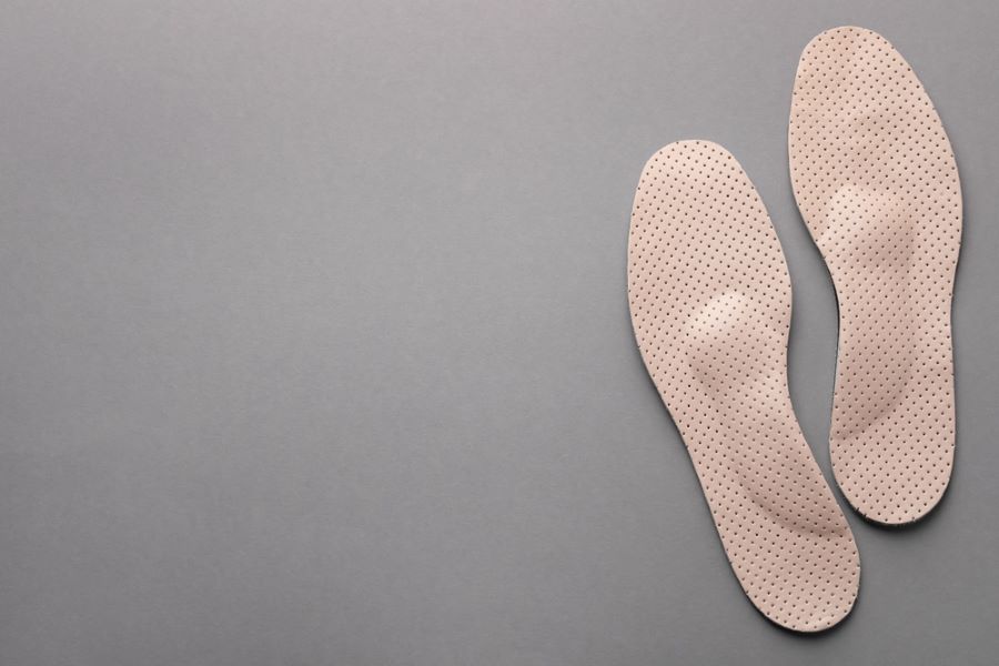  Light pink orthopedic insoles on  grey background