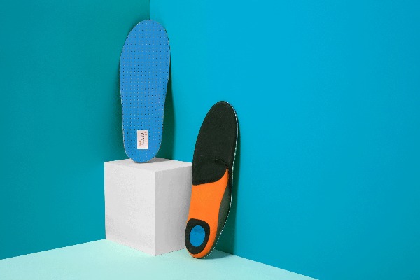 a pair of custom orthotics sitting on top of a white block
