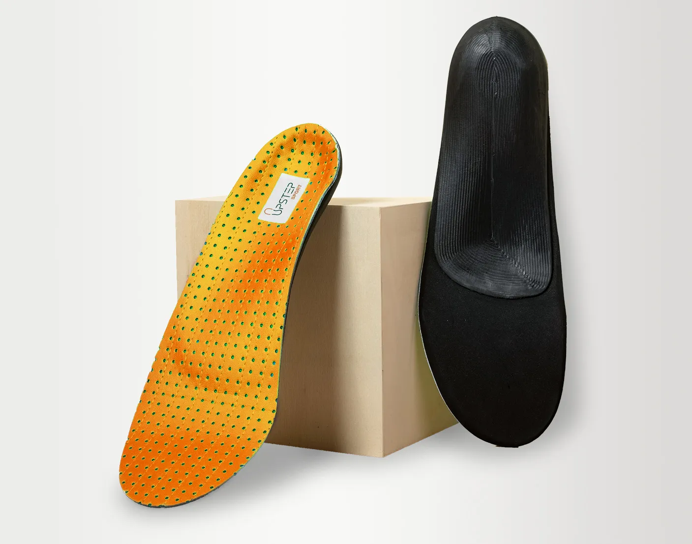 The topside and underside of Upstep custom orthotics for flat feet in orange, presented vertically