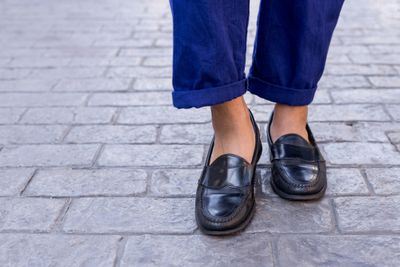 A close up of someone wearing loafers with custom insoles.