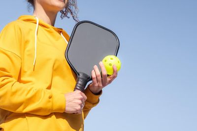 Preventing pickleball injuries:  a woman holding a racket.