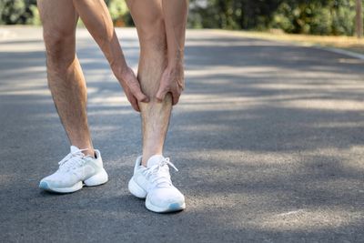 Young runner is suffering from shin splints