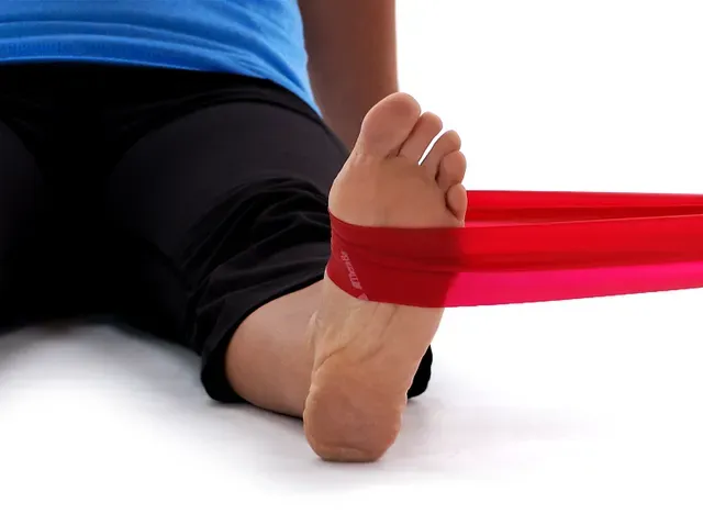 a person with a red band around their ankles