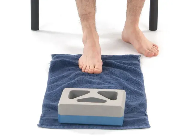 a person standing on a towel with a foot on a scale