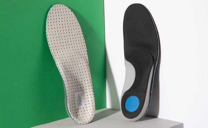 Grey and black insoles on a box with the front and back on display