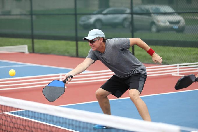 A man wearing pickleball goggles as a must-have accessory to shield his eyes from sunlight