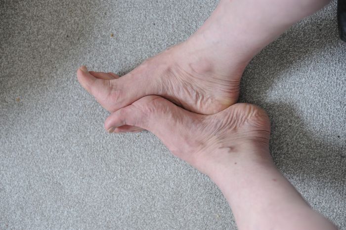 Feet placed together touching one another