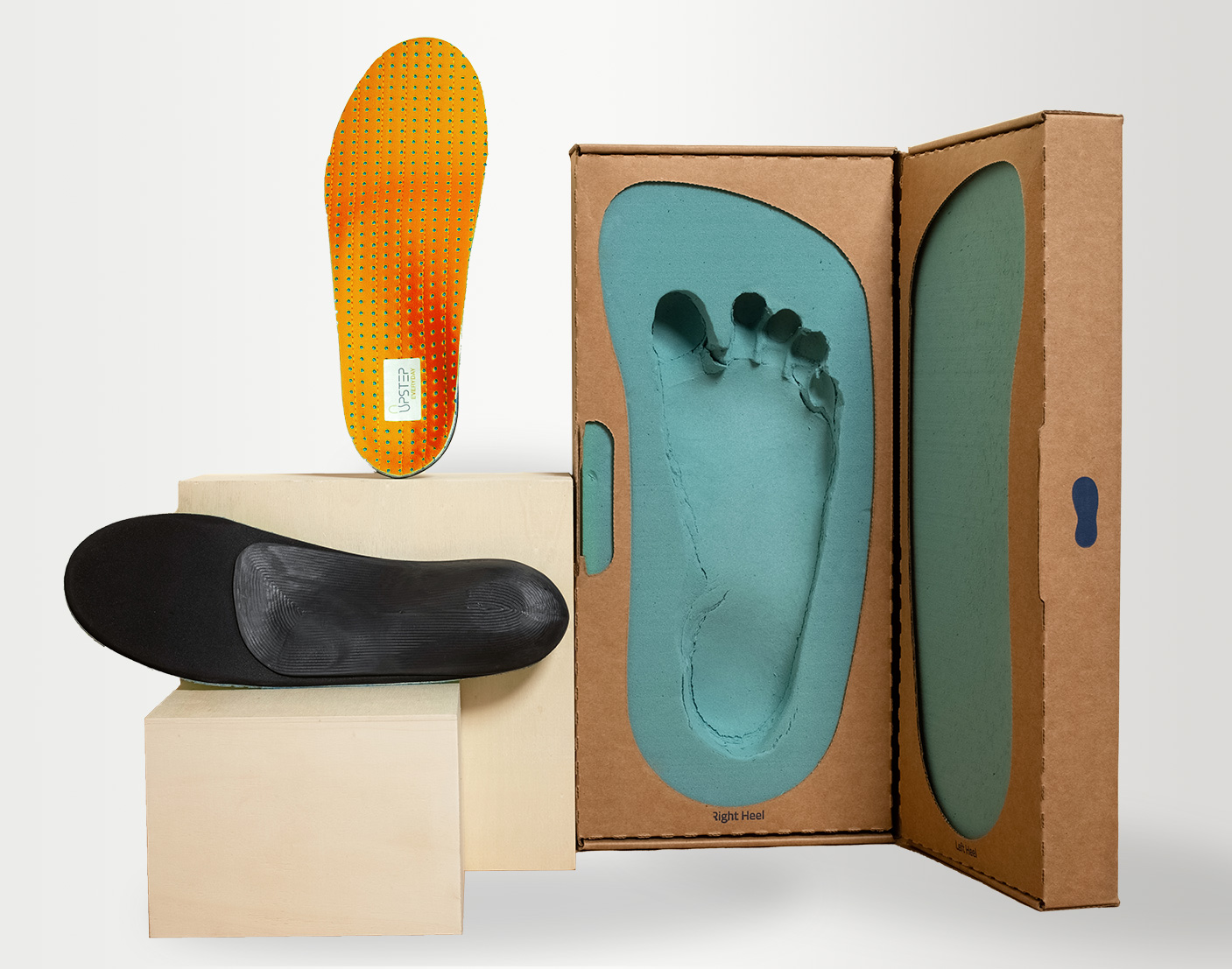 A shoe and a upstep custom insole for flat feet in orange, next to an insole mold