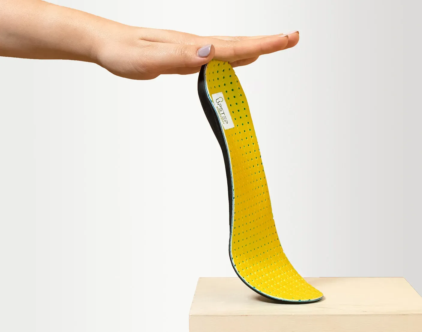 Upstep custom insole for overpronation in yellow, presented from the side
