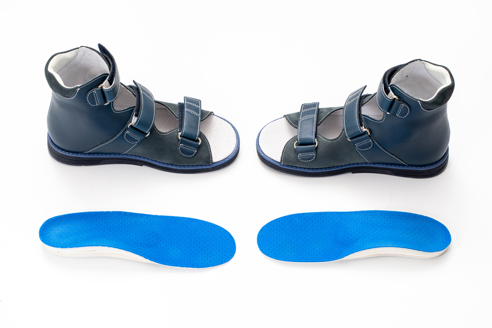 Orthopedic shoes and insoles isolated on a white background. 